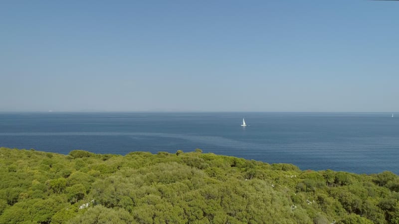 Aerial view of Lefkada island with a boat in the horizon.