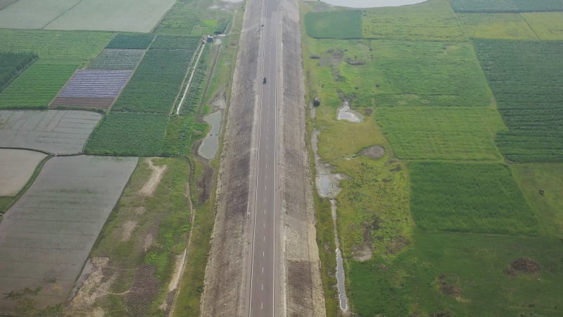 Aerial view of a road among the fields in Sapahar, Rajshahi, Bangladesh.