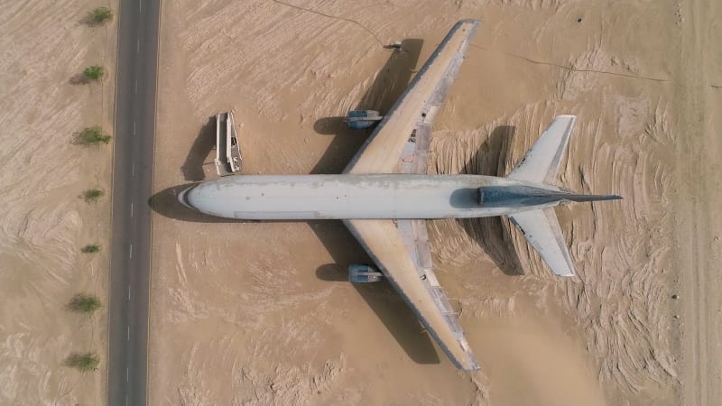 Aerial view above of museum airplane on desert landscape