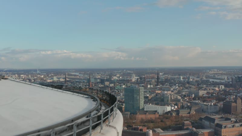 Aerial reveal of Hamburg city center with famous buildings and landmarks behind Heinrich Hertz TV tower observation deck