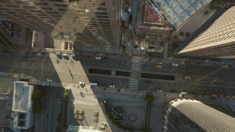 Slow Circling above Downtown Main Road in between Huge Skyscrapers Urban Canyon of Los Angeles, California Skyline, Aerial Birds Eye Overhead Top Down View