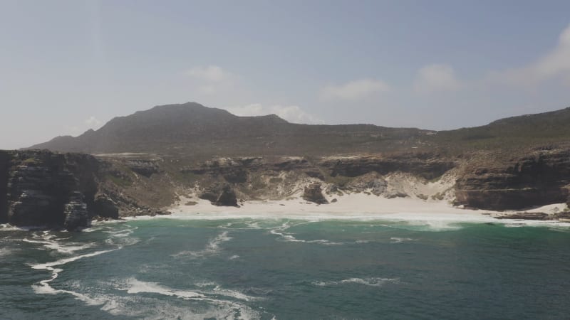 Most southern point of Africa with rocky cliffs and blue sea