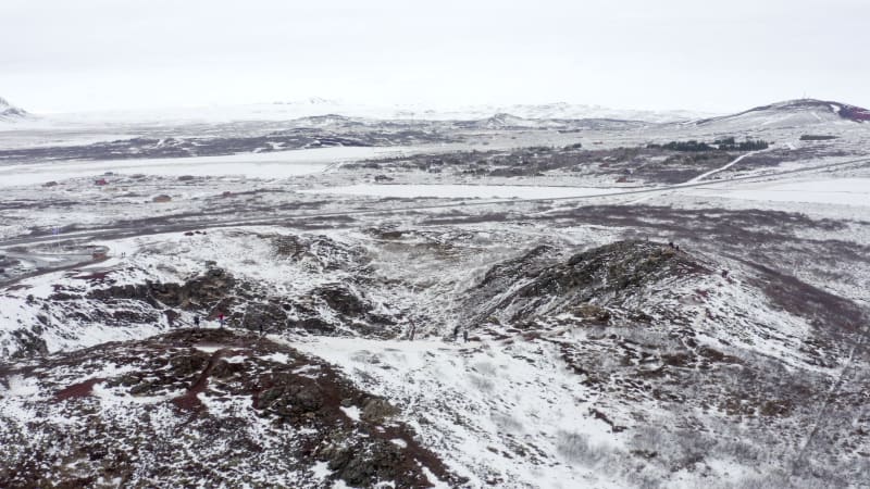 Tourists Looking in to the Snowy Kerid Crater in Iceland Seen From the Air