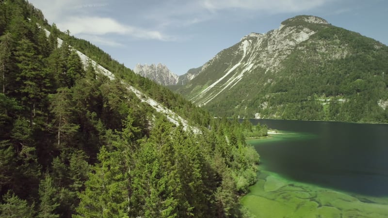 Aerial view of Lago del Predil surrounded by hills.