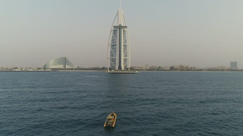 Aerial view of the luxurious Burj Al Arab Hotel and yellow boat.