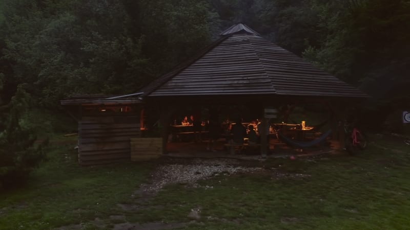 Aerial view of a wooden open hut with people enjoying the night.