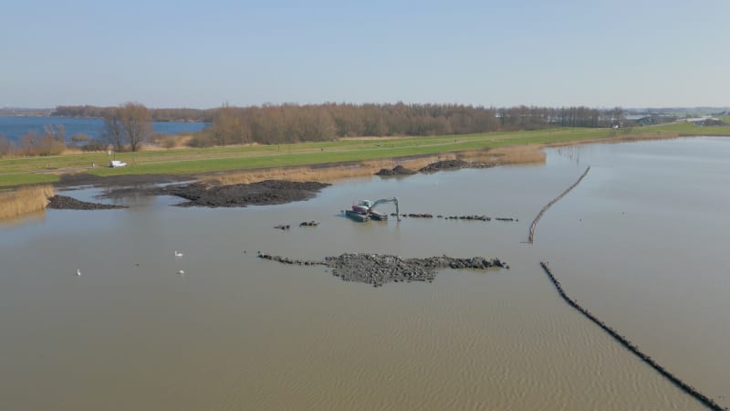 Excavator working in lake