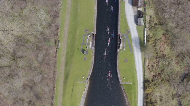 A Large Group of Canoeists Traversing a Canal Lock