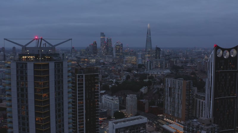 Elevated footage of tall residential buildings in Elephant and Castle urban district. Cityscape at dusk. London, UK