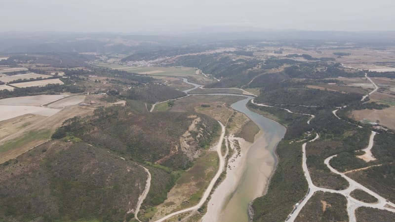 Aerial view of Praia de Odeceixe along Ribeira de Seixe river, Faro, Portugal.