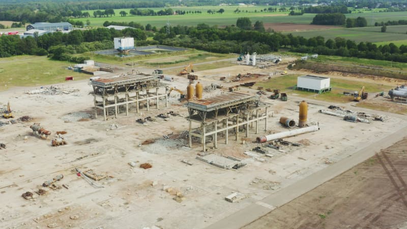 Demolished building site with rubble and construction vehicles