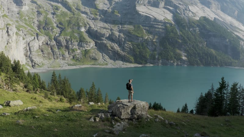 Aerial view of a person in front of Oeschinensee Lake, Bern, Switzerland.