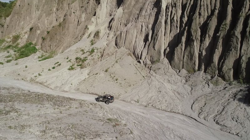 Aerial view of road in valley with a off road jeep in Tarlac.