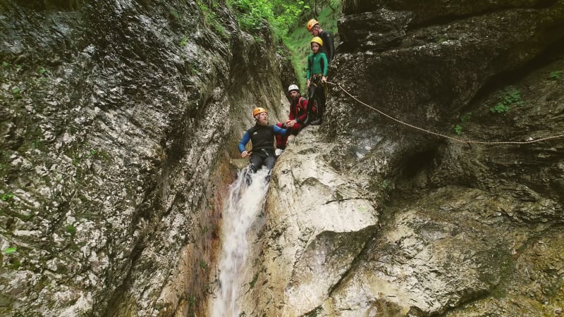 Aerial view of man throwing himself through a sliding rock.