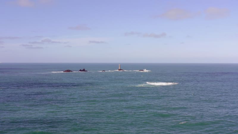 Isolated Lighthouse at Sea on a Rock During the Summer