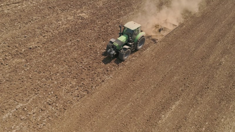 Aerial view of a tractor ploughing an empty field, Kibbutz saar, Israel.