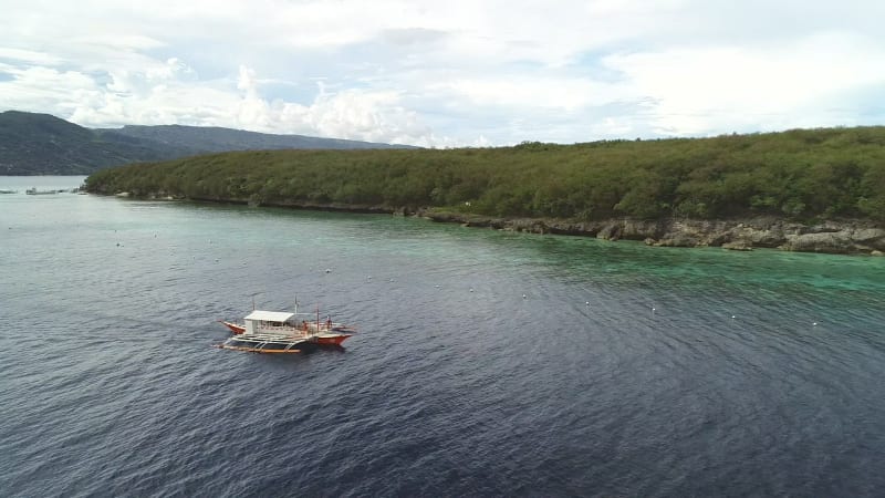 Aerial view of single filipino fishing boat near Lapu-Lapu city.