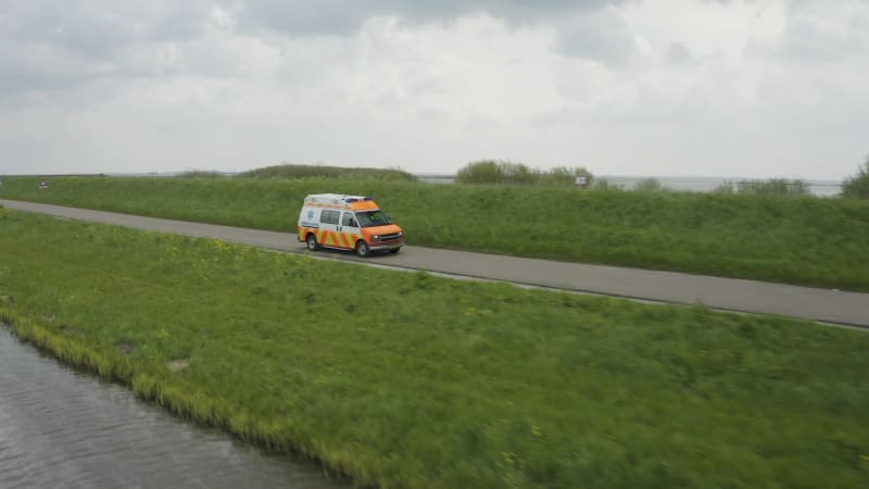 Urgent Mission: Ambulance Driving Over a Dike in the Netherlands