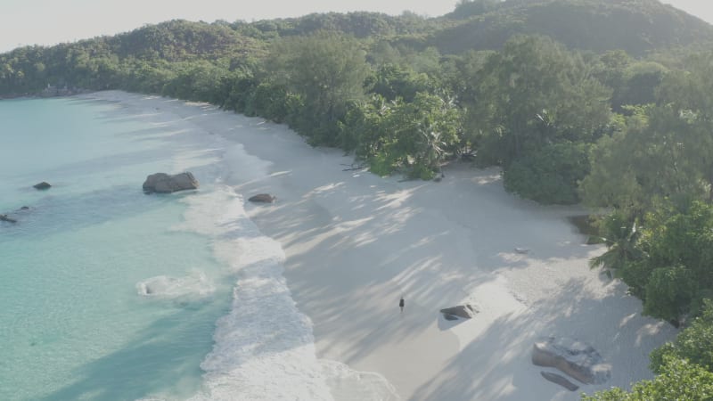 Aerial view of a person walking on the beach of Anse Lazio, Seychelles.