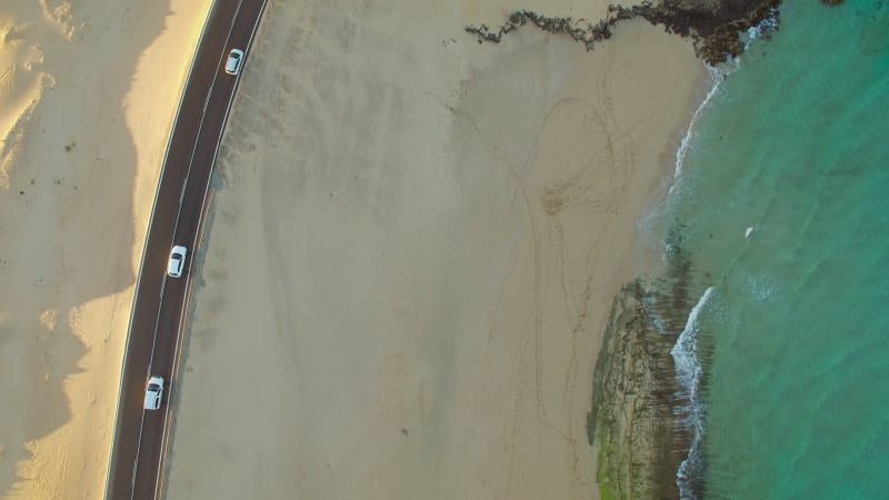 Aerial view of cars on the road of Corralejo Dunes Natural Park.