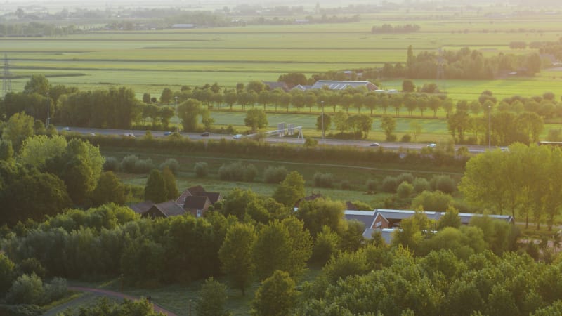 Cars driving on a busy highway through rural Netherlands