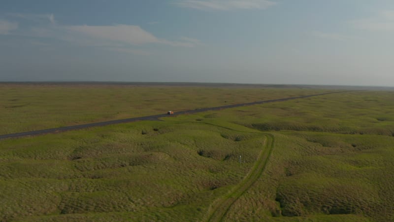 aerial view car driving on Ring Road, the most important highway in Iceland. Drone view car travelling on Ring Road discovering uninhabited parts of Iceland