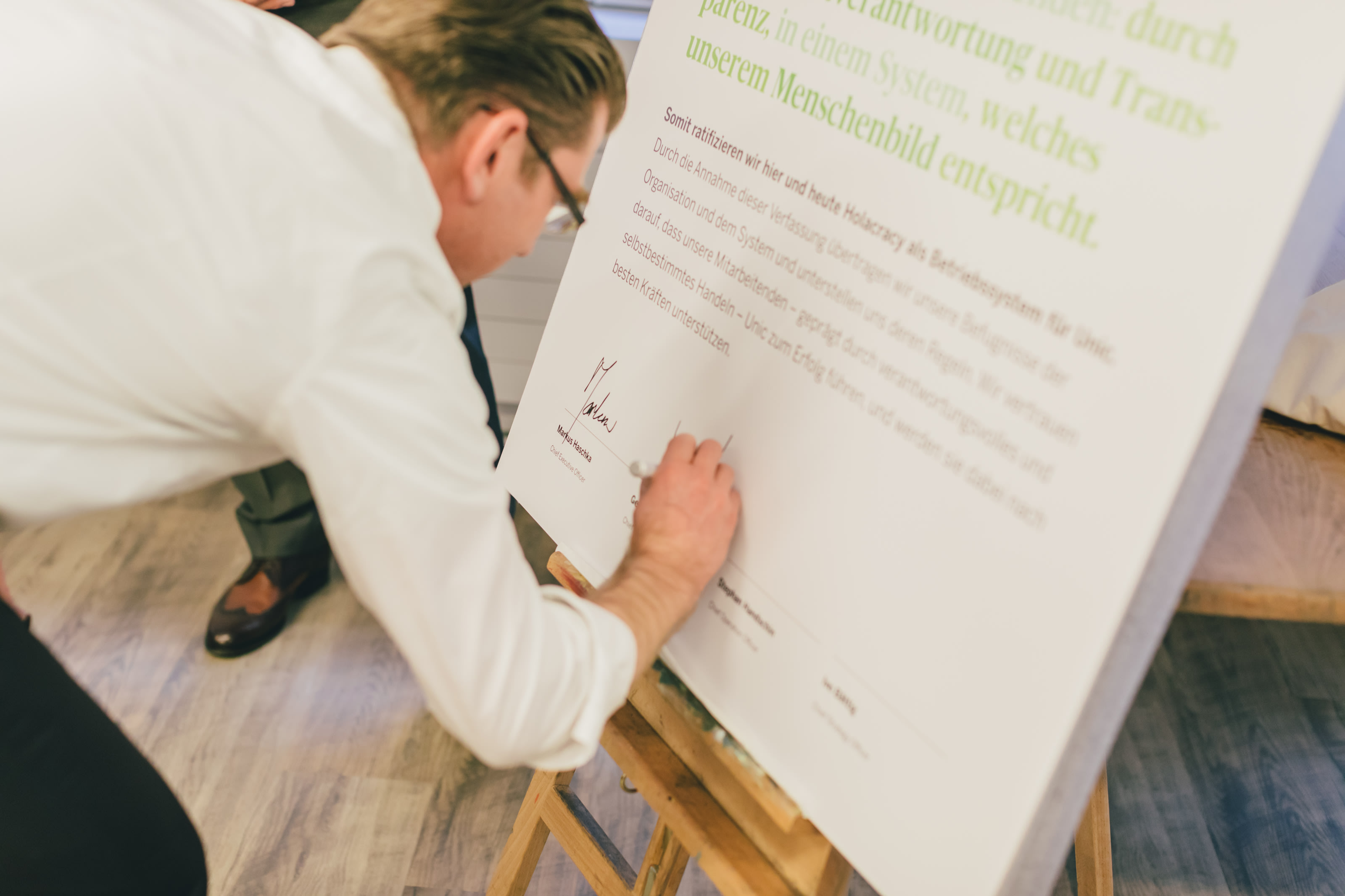 Gerrit Taaks, founder of Unic, signs the Holacracy Constitution.