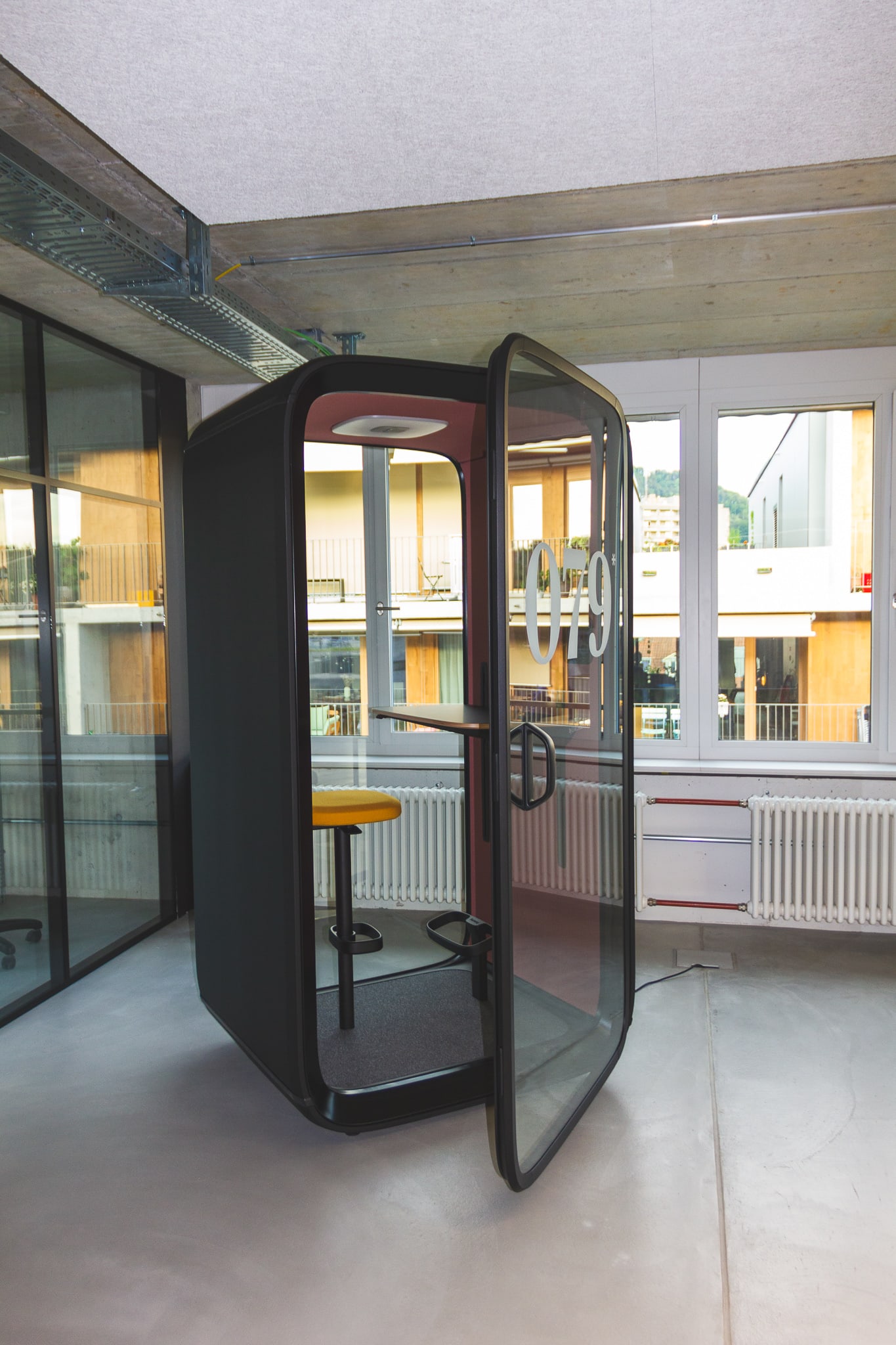 Telephone box - soundproof workstation with the look of a telephone box.