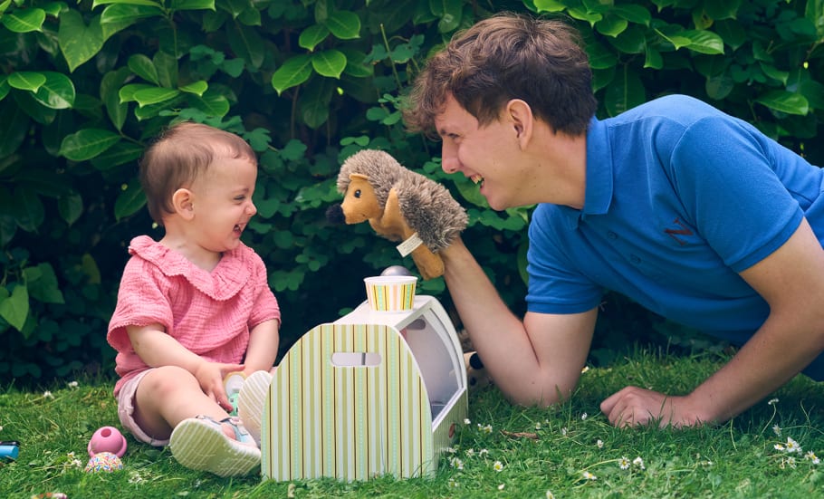 Image of a student with a child having imaginative play fun