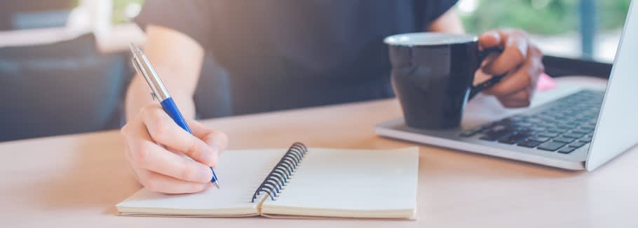 Image of a student making notes after a university application