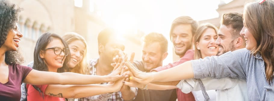 Image of a group of students with arms together