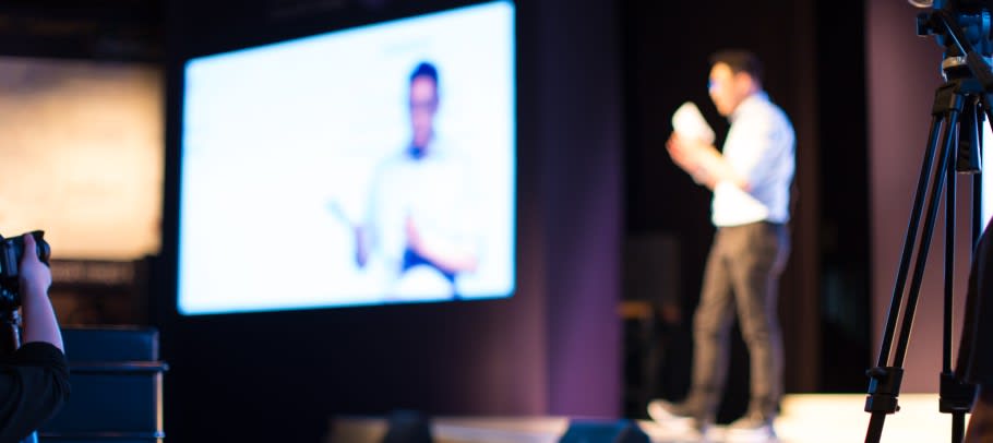 Image of a hybrid university event - on campus and delivered online too.