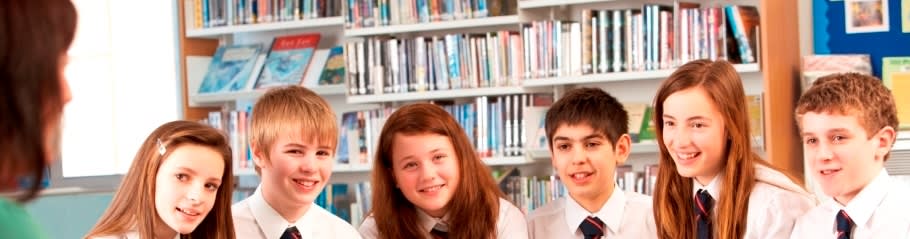 younger students talking to a member of staff at a university at a career fair