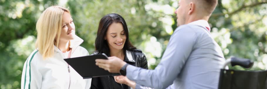 An image of two students chatting to a university adviser