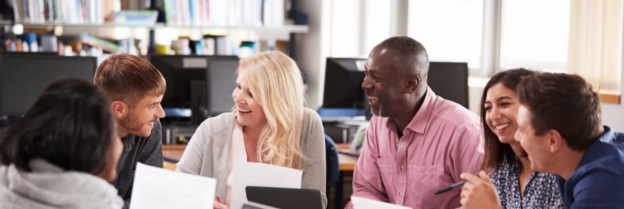 Image of students working on their personal statements supported by teachers