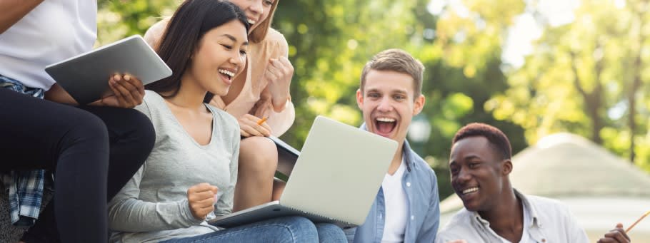 Image of a group of students checking on their university applications