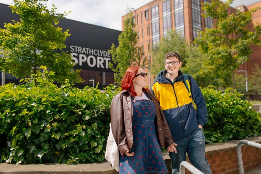 Two prospective students in front of Strathclyde Sport on a visit day.