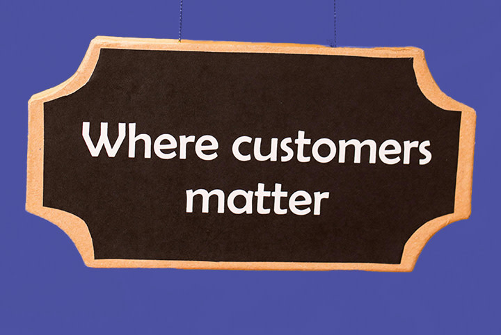 Sign with golden edge and black background with white inscription ‘Where customers matter’