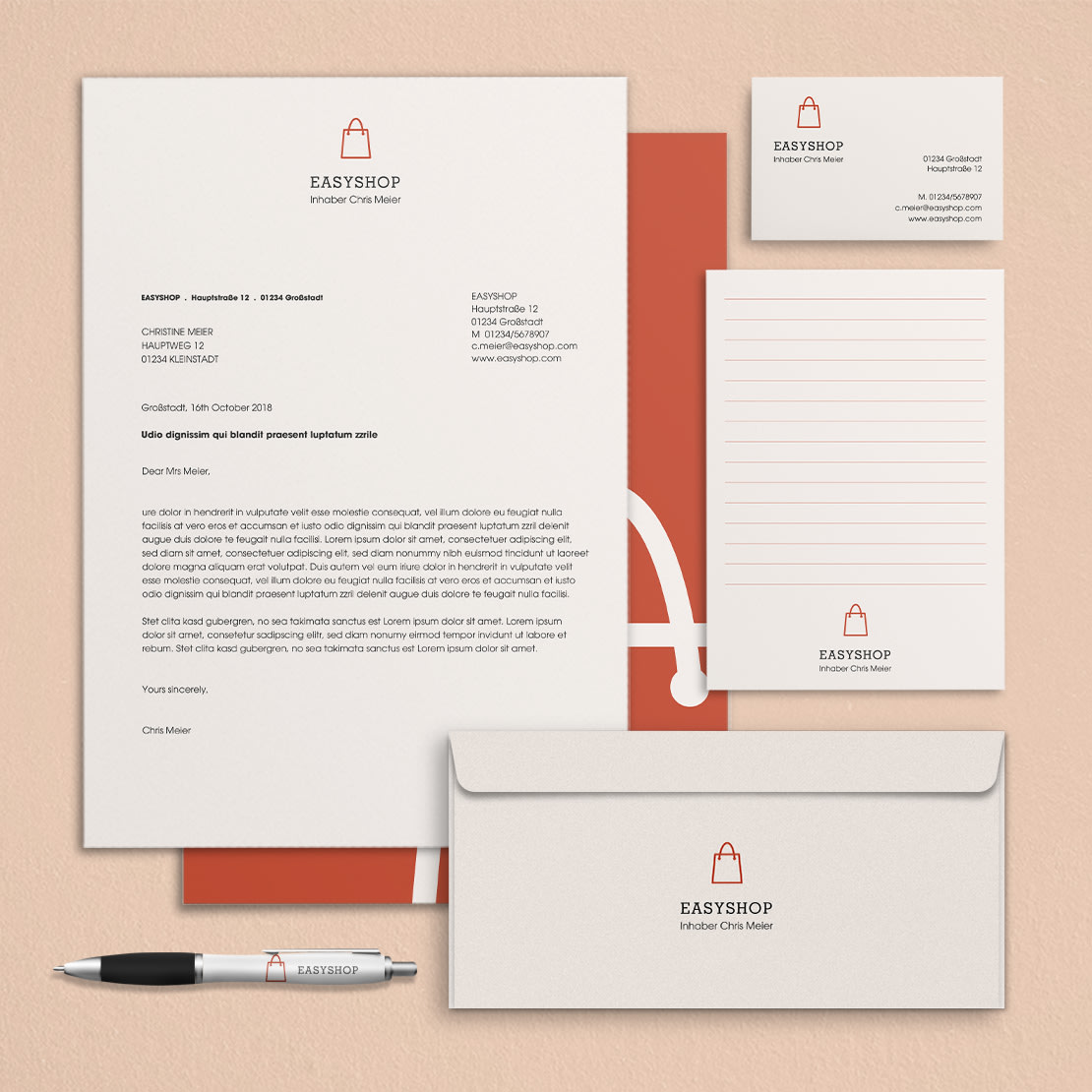 Branchenkachel für Einzelhandel und Verkauf: Geschäftspapier-Set: Briefpapier, Visitenkarte, Notizblock, Umschlag und Kugelschreiber, alle bedruckt mit Logo und Kontaktinformationen.