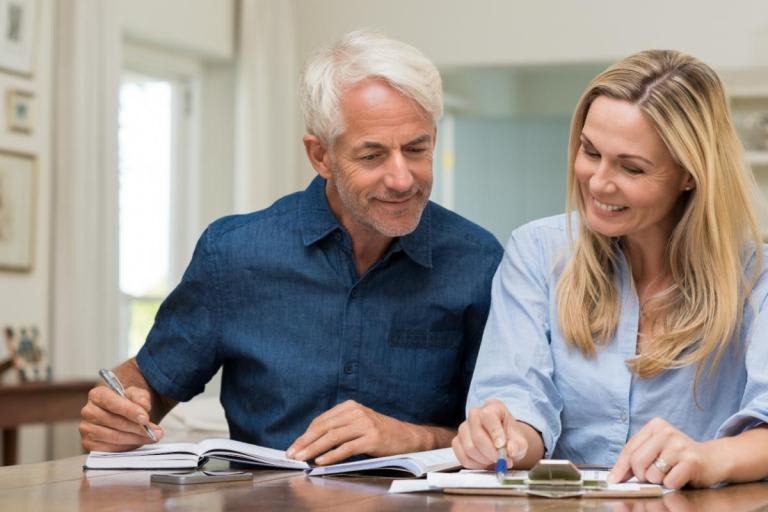 Husband and wife looking over budget