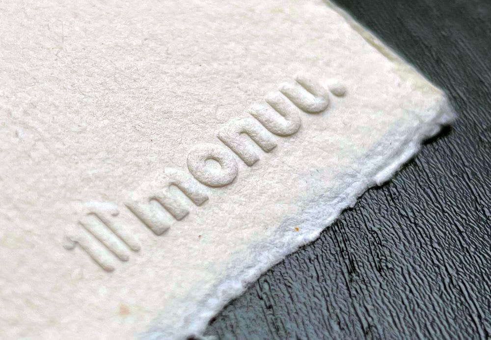 Embossing of the Monuu logo in the paper of a drawing