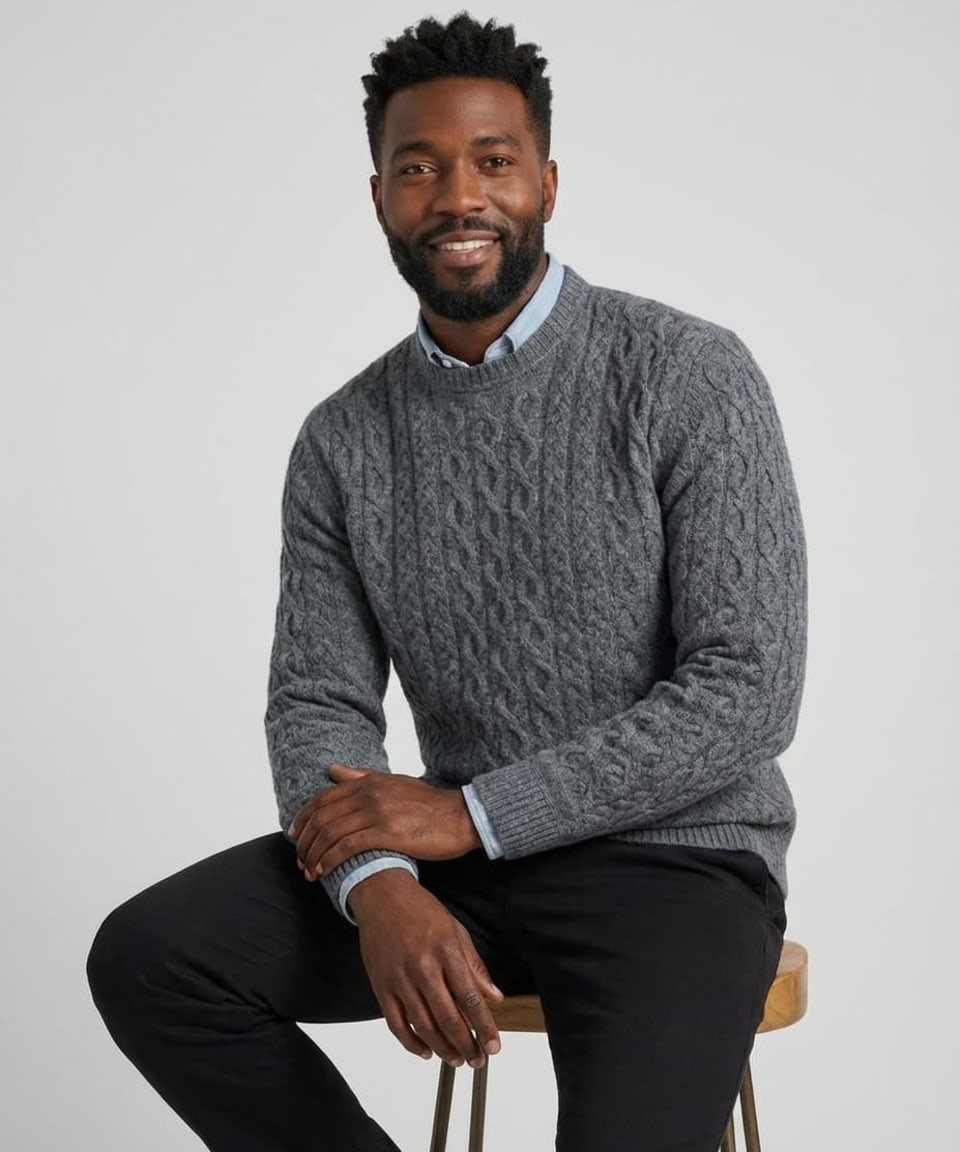 Man wearing a charcoal grey cashmere cable-knit jumper with crew neckline and ribbed trims at collar, cuffs and hem, layered over a light blue shirt – Unur