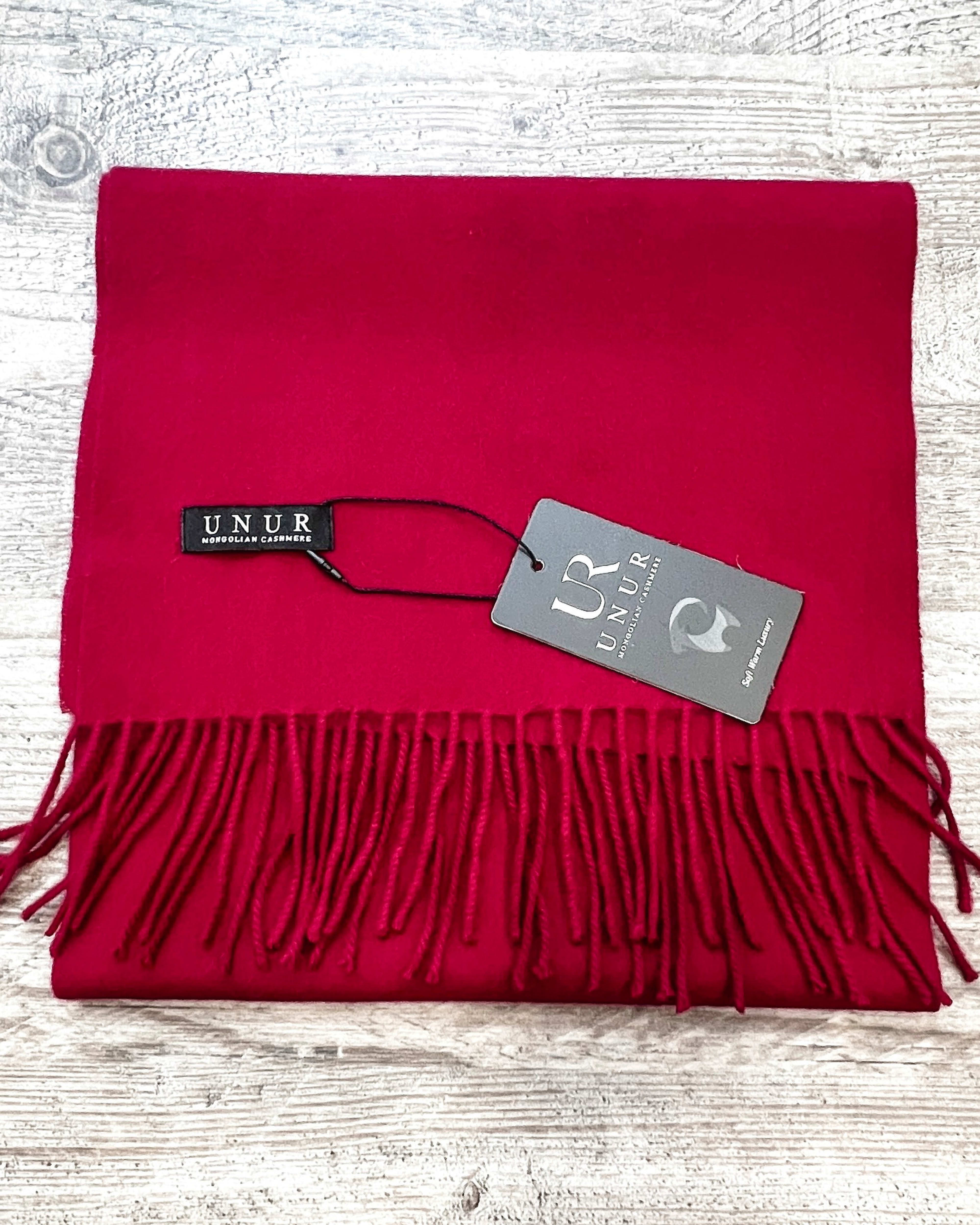 Lay-flat close up of burgundy unisex woven cashmere scarf with tassles