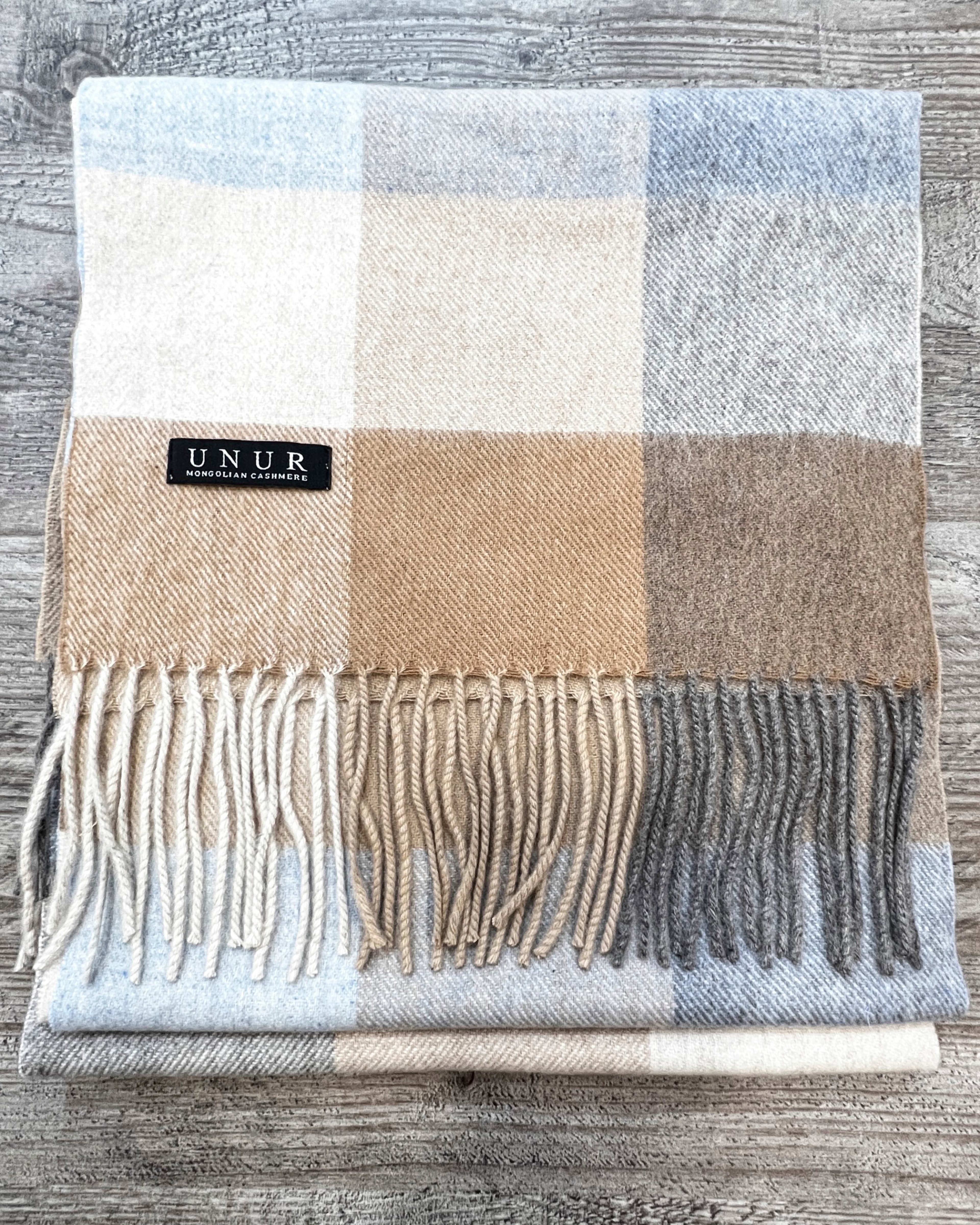 Lay-flat close up of check brown unisex woven cashmere scarf with tassles