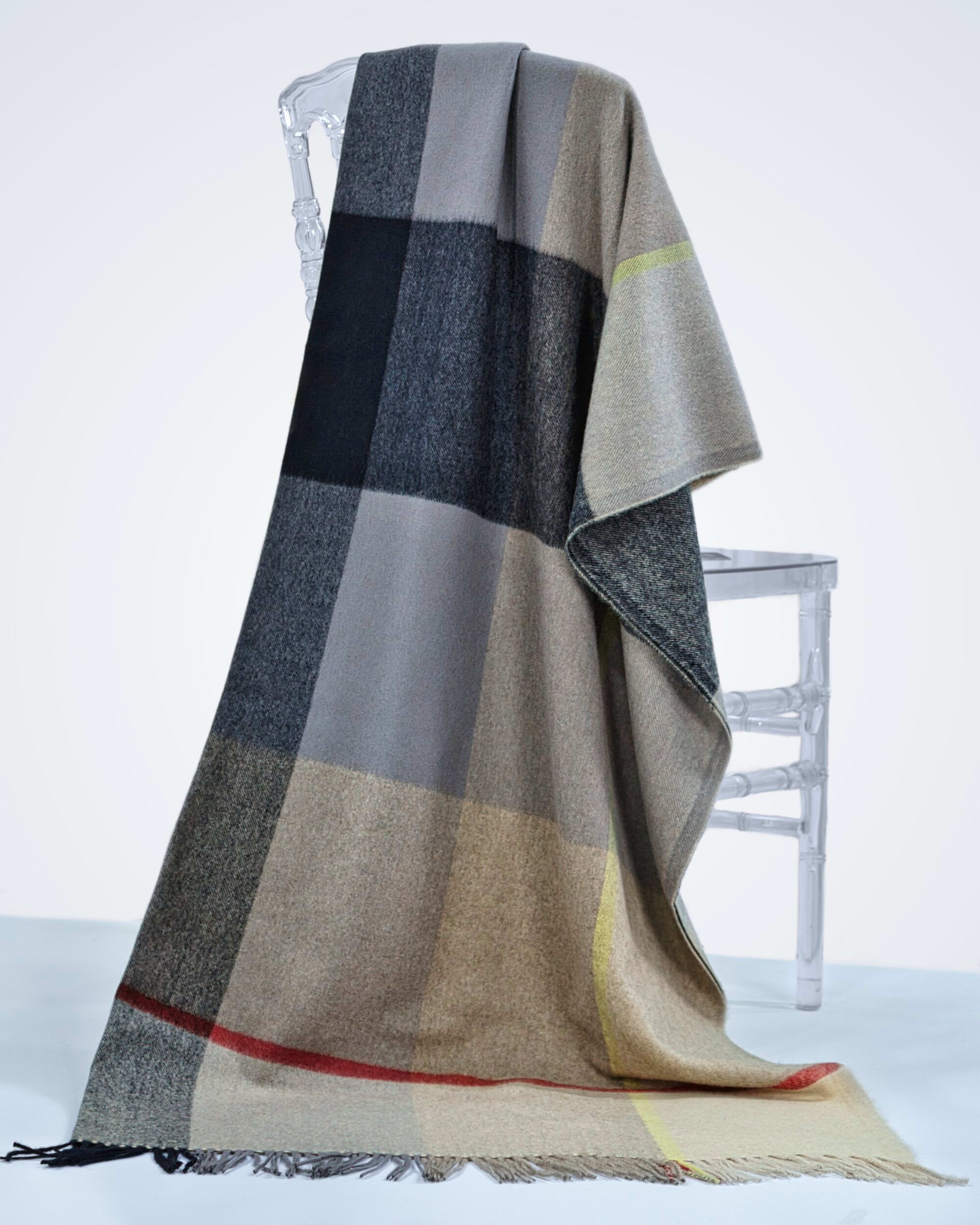 check plaid cashmere blanket draped over a chair