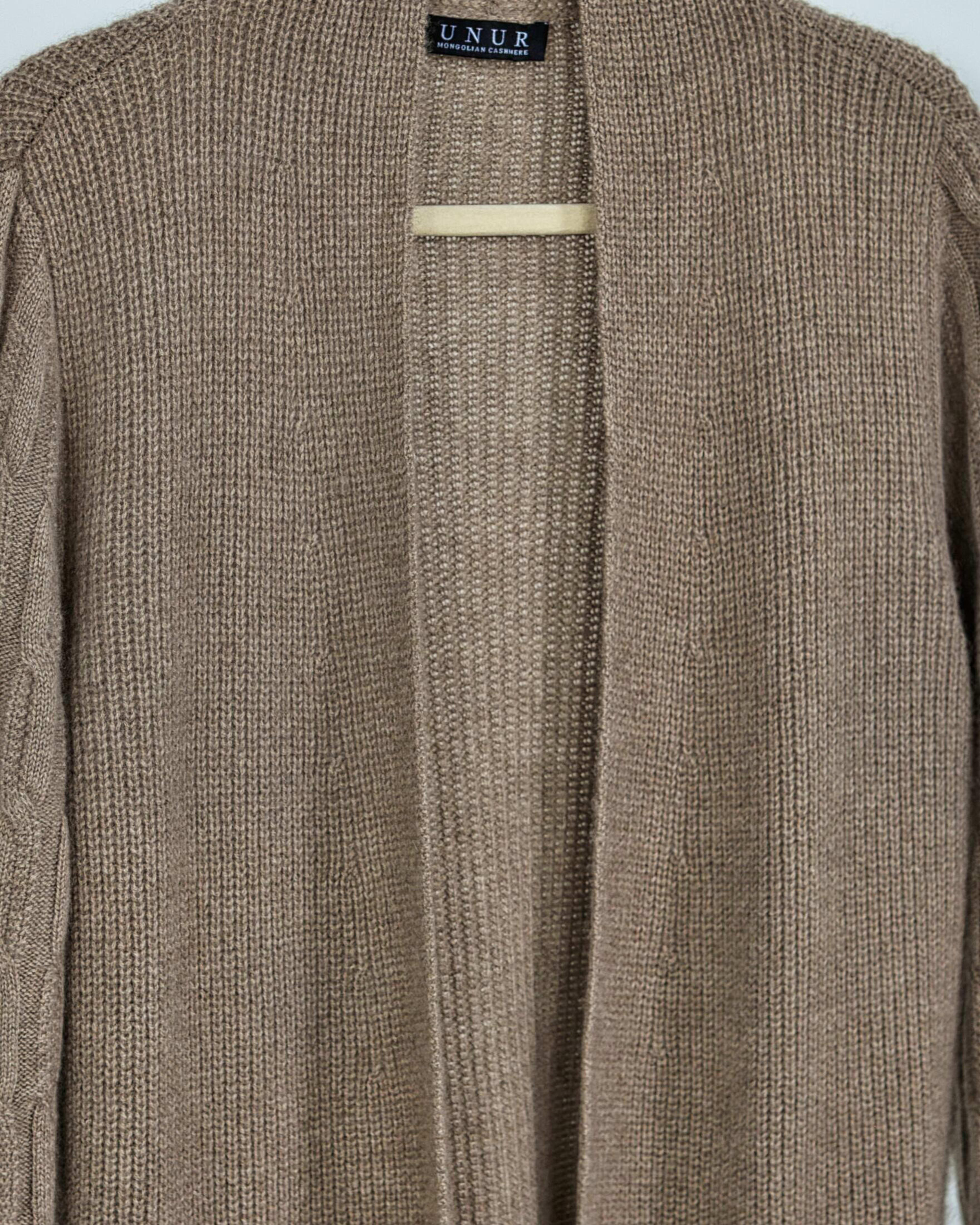 Close-up of soft cashmere ribbed cardigan in natural brown