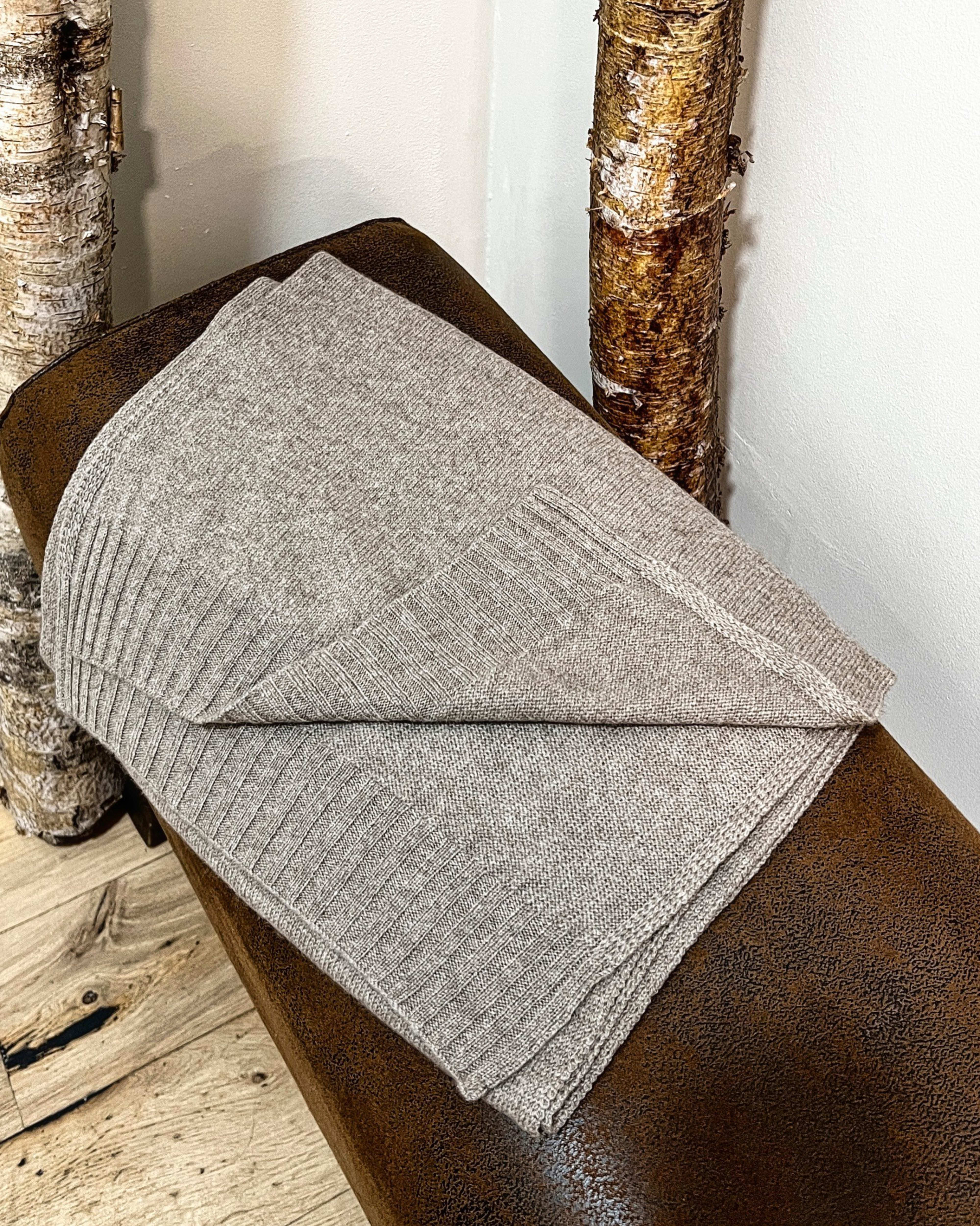 Natural brown cashmere shawl on neutral background, flat view