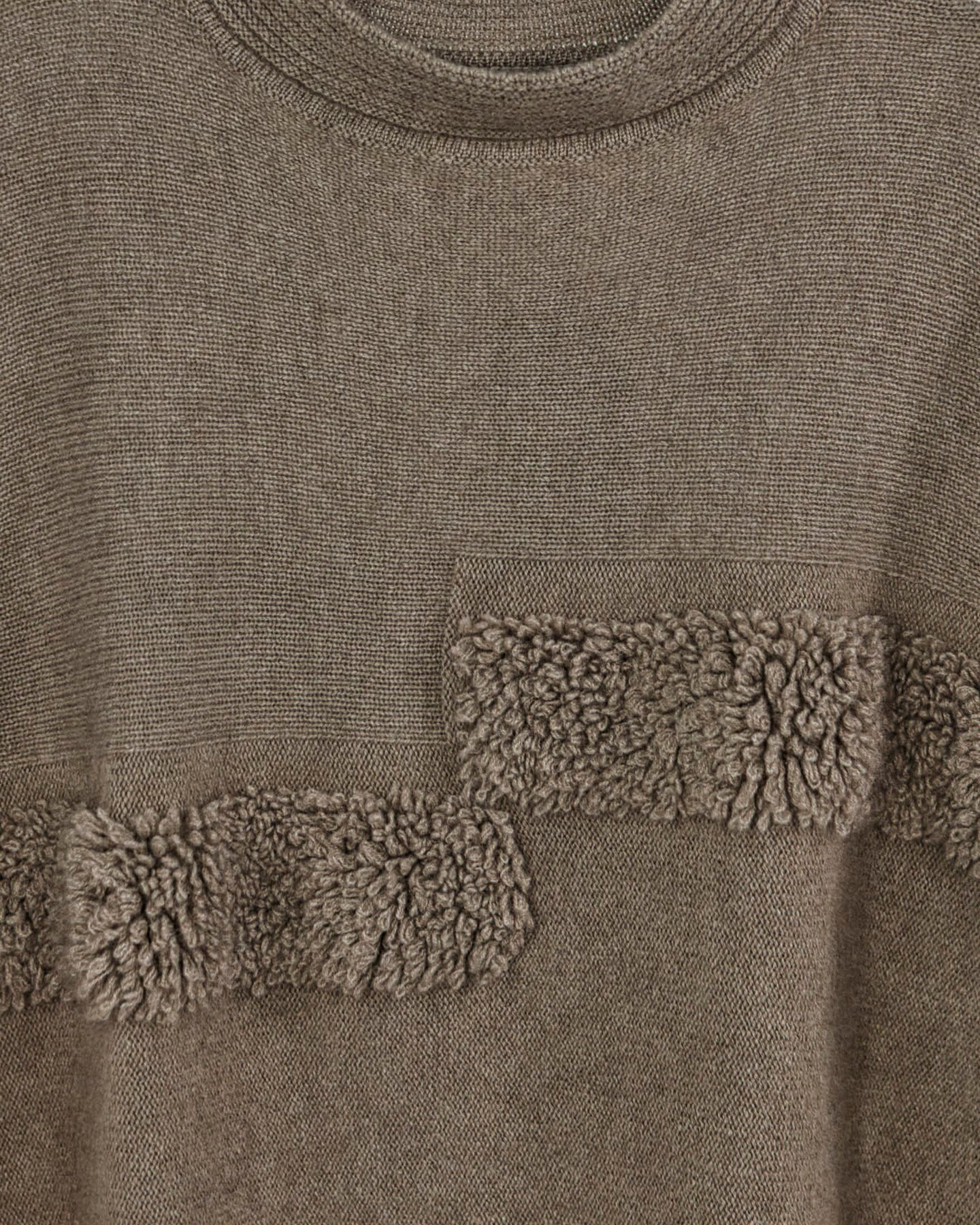Close-up of natural brown cashmere cape top showing soft boucle texture