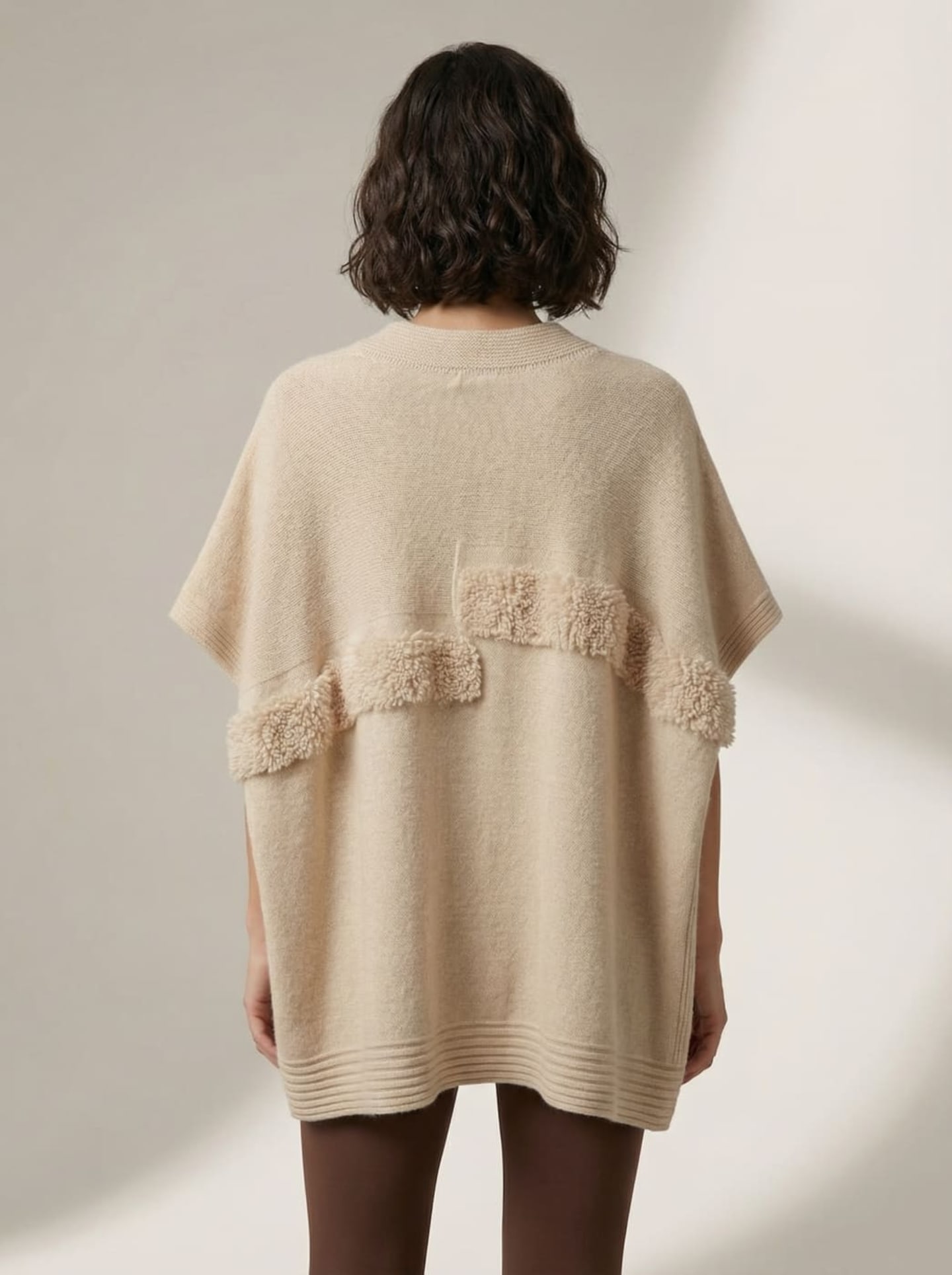 Back view of natural beige cashmere cape top showing horizontal boucle panel