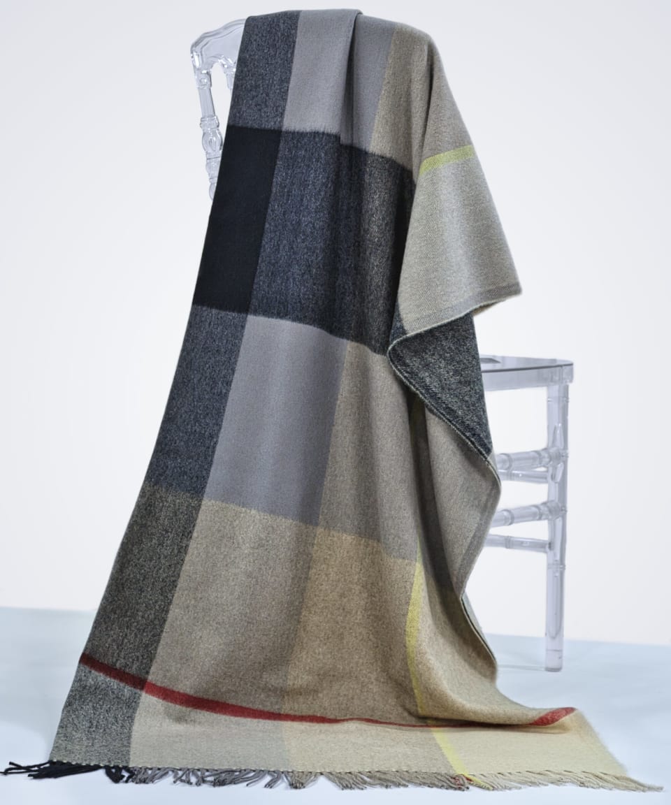 check plaid cashmere blanket draped over a chair